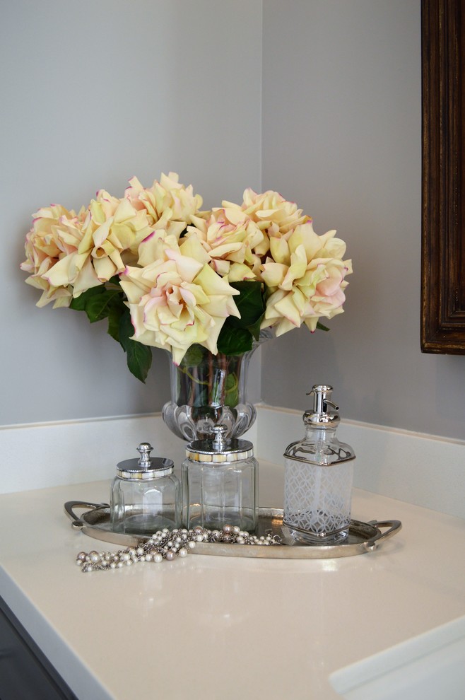 Transitional porcelain tile bathroom photo in Phoenix with recessed-panel cabinets, gray cabinets, gray walls, an undermount sink and solid surface countertops