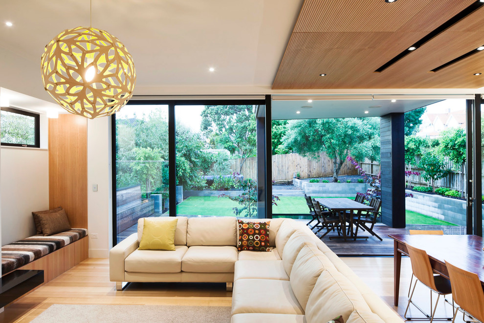 Design ideas for a contemporary open concept living room in Auckland with white walls.
