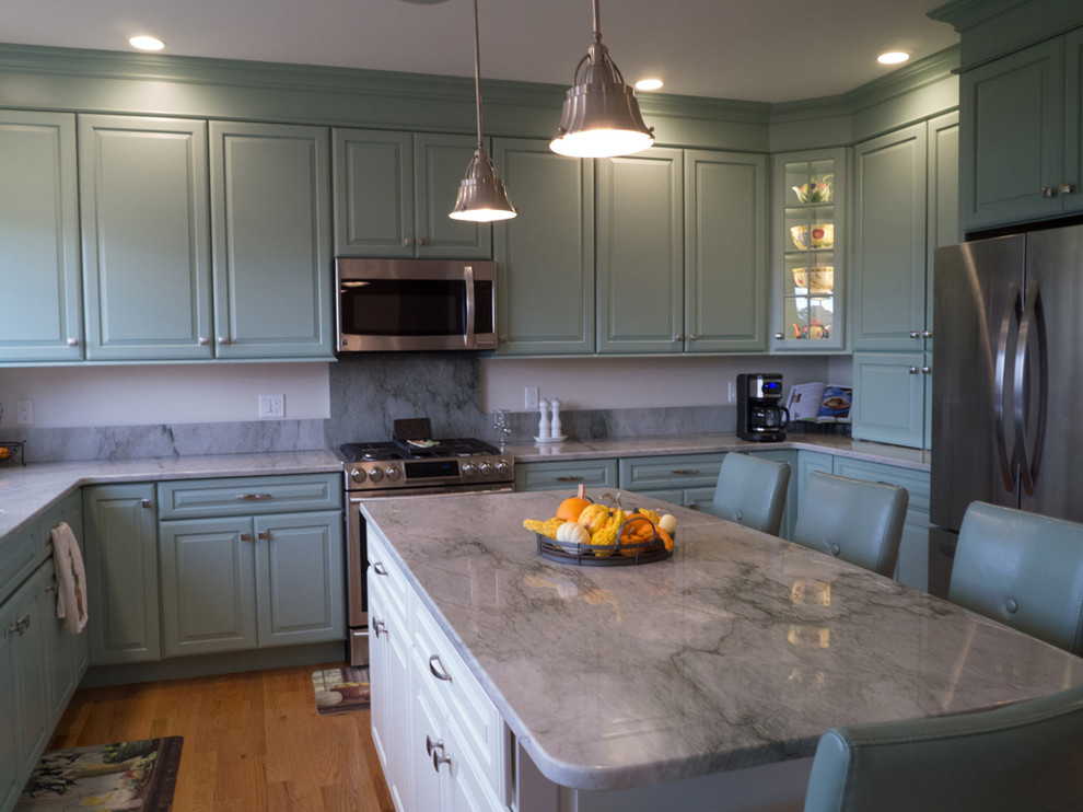 Inspiration for a large beach style eat-in kitchen in Providence with raised-panel cabinets, blue cabinets, granite benchtops, blue splashback, ceramic splashback, stainless steel appliances, light hardwood floors and with island.