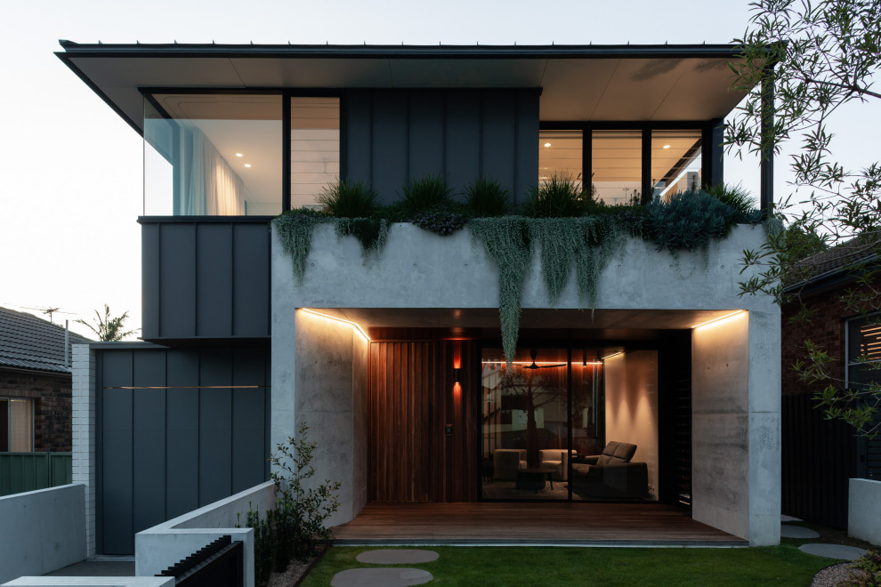 Large contemporary two-storey concrete house exterior in Sydney.