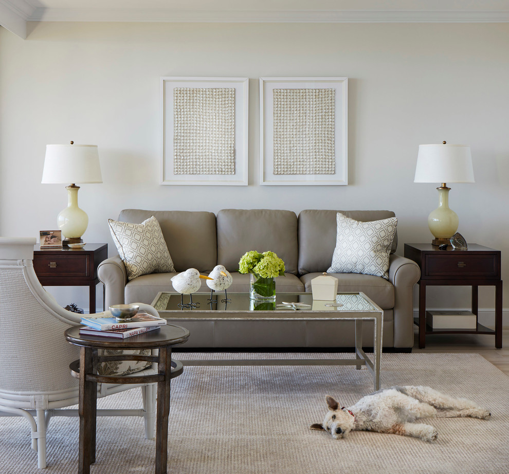Inspiration for a mid-sized transitional open concept family room in Miami with beige walls and light hardwood floors.