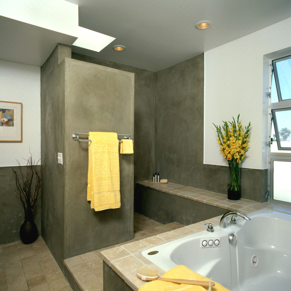 Photo of a modern bathroom in Los Angeles with a drop-in tub, an open shower, beige tile and an open shower.