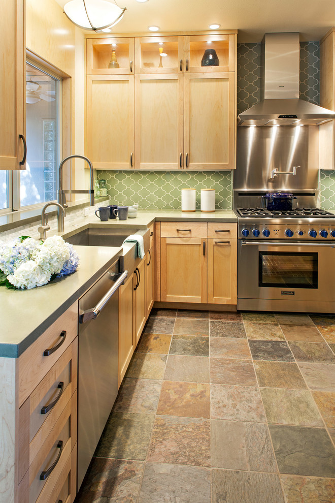 Inspiration for a mid-sized transitional l-shaped slate floor eat-in kitchen remodel in Austin with an undermount sink, recessed-panel cabinets, light wood cabinets, green backsplash, stainless steel appliances and an island