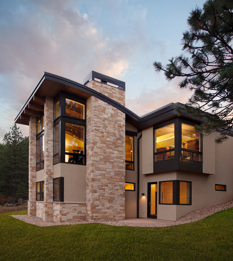 Inspiration for a large modern beige two-story mixed siding flat roof remodel in Denver