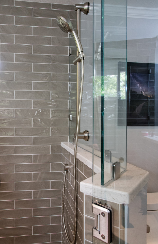 This is an example of a mid-sized transitional master bathroom in Seattle with brown cabinets, a double shower, a two-piece toilet, ceramic tile, an undermount sink, engineered quartz benchtops, brown floor, a hinged shower door, recessed-panel cabinets, beige tile, beige walls, porcelain floors, a shower seat, a double vanity, a built-in vanity and white benchtops.
