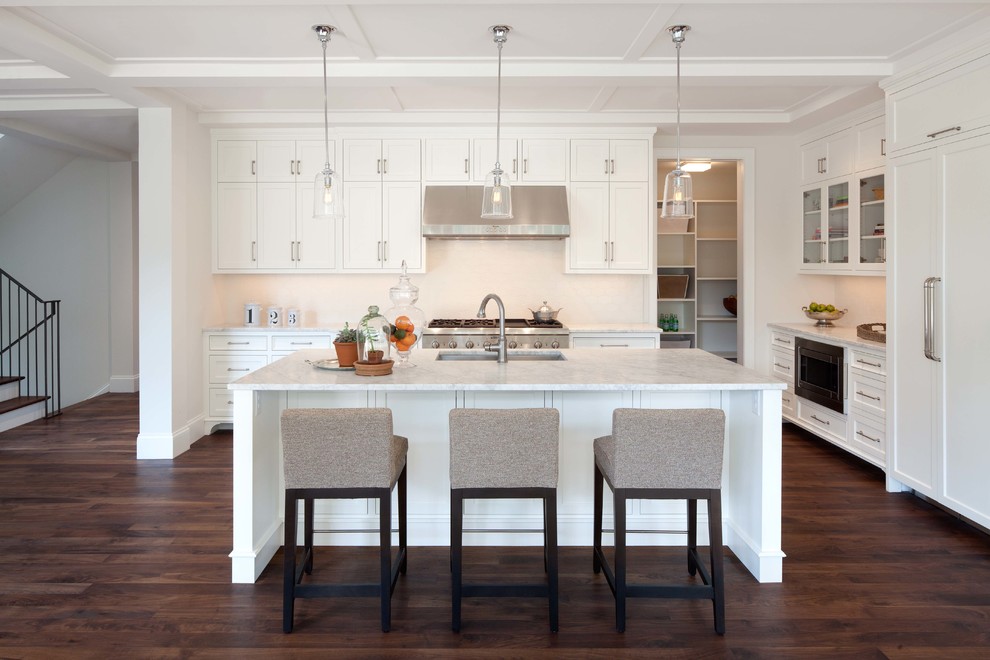This is an example of a traditional kitchen in Minneapolis with an undermount sink, recessed-panel cabinets, white cabinets, white splashback and stainless steel appliances.