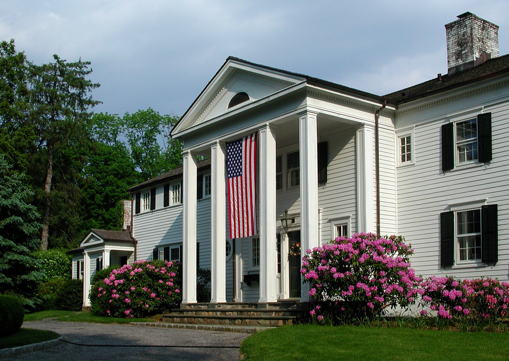 Large traditional white two-story wood gable roof idea in New York