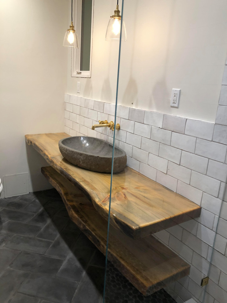 This is an example of a mid-sized country master bathroom in San Diego with an open shower, white tile, terra-cotta tile, white walls, slate floors, a vessel sink, wood benchtops, grey floor, a hinged shower door, brown benchtops, a single vanity and a floating vanity.