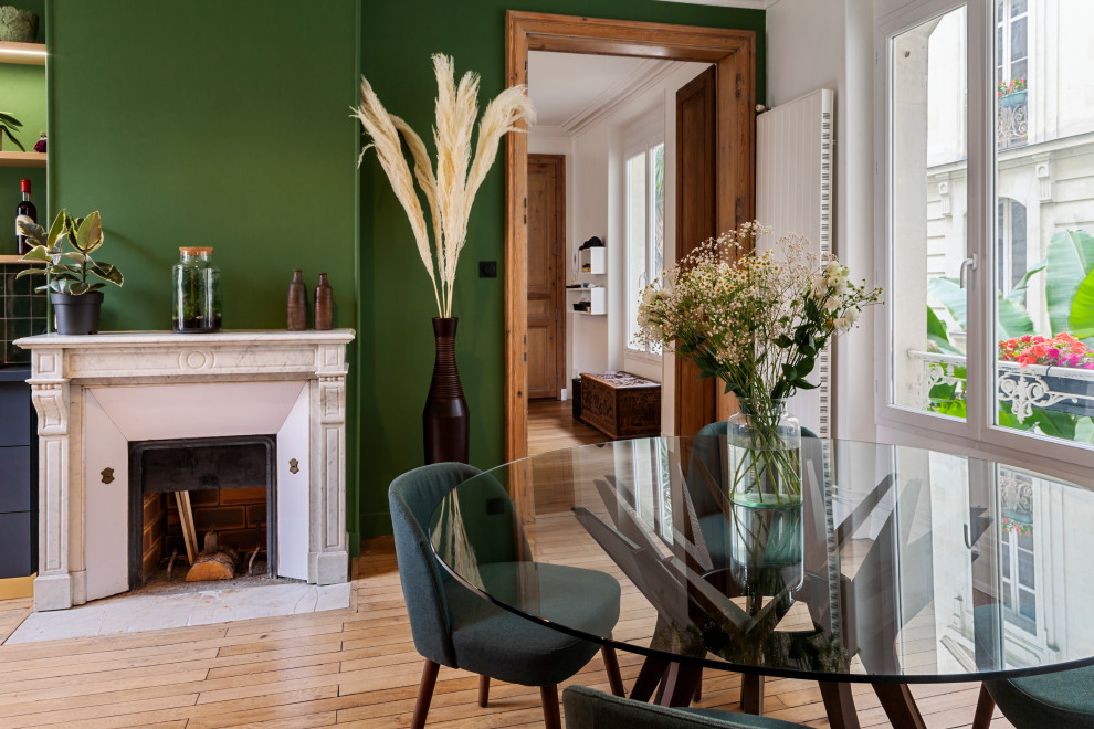 Réalisation d'une salle de séjour tradition de taille moyenne et ouverte avec un mur vert, parquet clair, une cheminée standard et un manteau de cheminée en pierre.