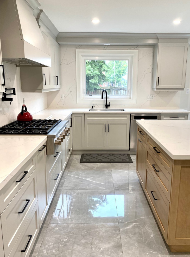 Inspiration for a mid-sized transitional l-shaped porcelain tile open concept kitchen remodel in Toronto with an undermount sink, shaker cabinets, gray cabinets, quartz countertops, white backsplash, quartz backsplash, stainless steel appliances, an island and white countertops