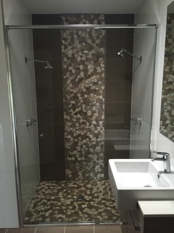 Small modern bathroom in Gold Coast - Tweed with flat-panel cabinets, brown cabinets, an alcove shower, brown tile, white tile, porcelain tile, white walls, cement tiles, a trough sink, brown floor and a hinged shower door.