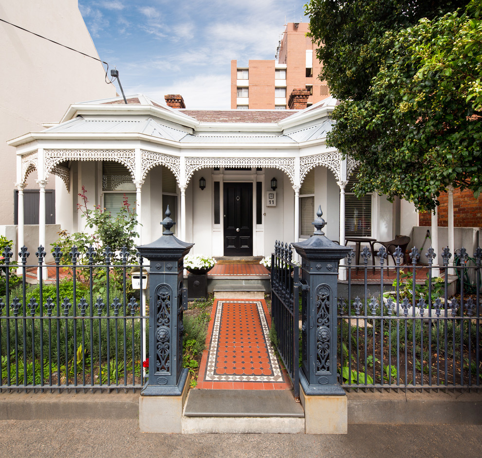 Mid-sized traditional one-storey white exterior in Melbourne with a hip roof and a mixed roof.