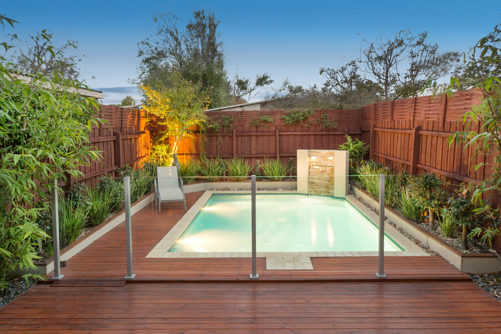 Design ideas for a modern backyard rectangular pool in Melbourne with decking.