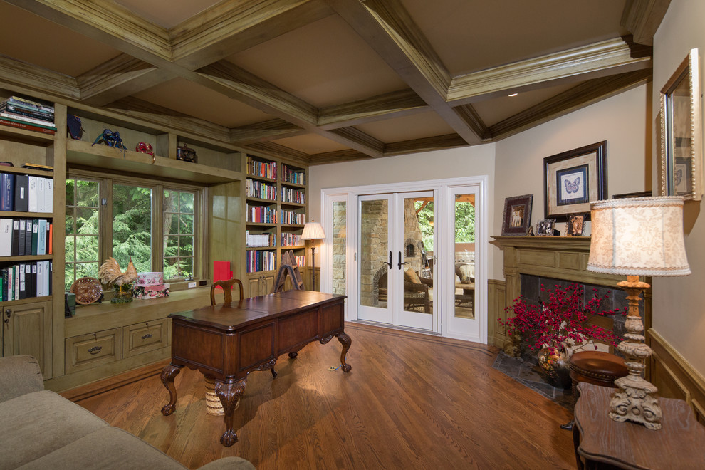 Large traditional home office in Chicago with medium hardwood floors, a corner fireplace, a freestanding desk and a tile fireplace surround.