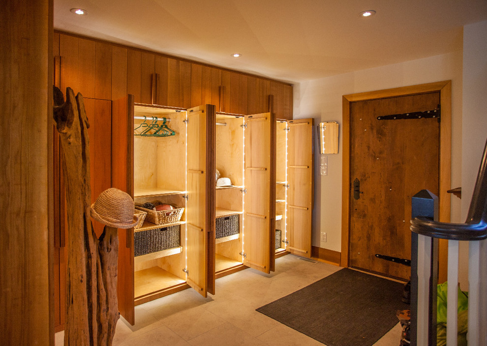 Mid-sized country mudroom in Toronto with a single front door and a medium wood front door.