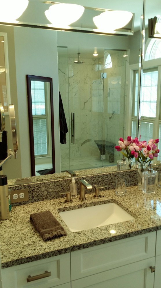 This is an example of a large modern master bathroom in Baltimore with shaker cabinets, white cabinets, an alcove shower, white tile, stone tile, white walls, an undermount sink and granite benchtops.