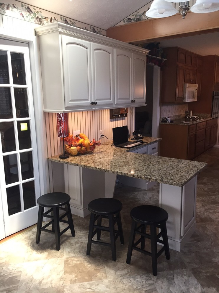 Inspiration for a small transitional l-shaped eat-in kitchen remodel with raised-panel cabinets, beige cabinets, granite countertops and a peninsula