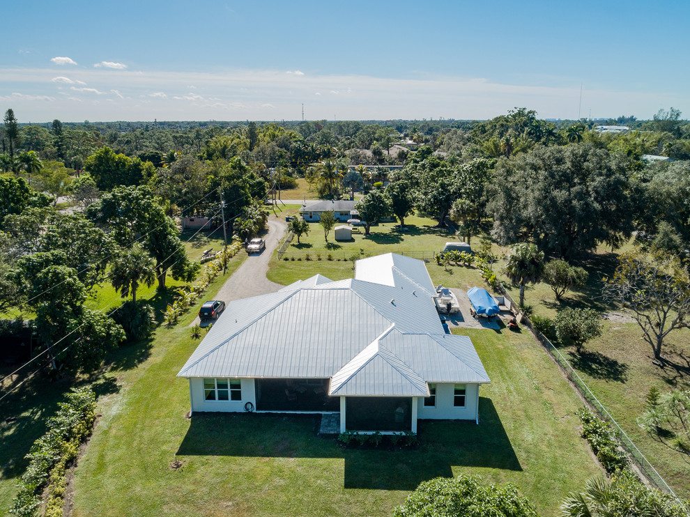 Mid-sized traditional white one-story vinyl house exterior idea with a metal roof