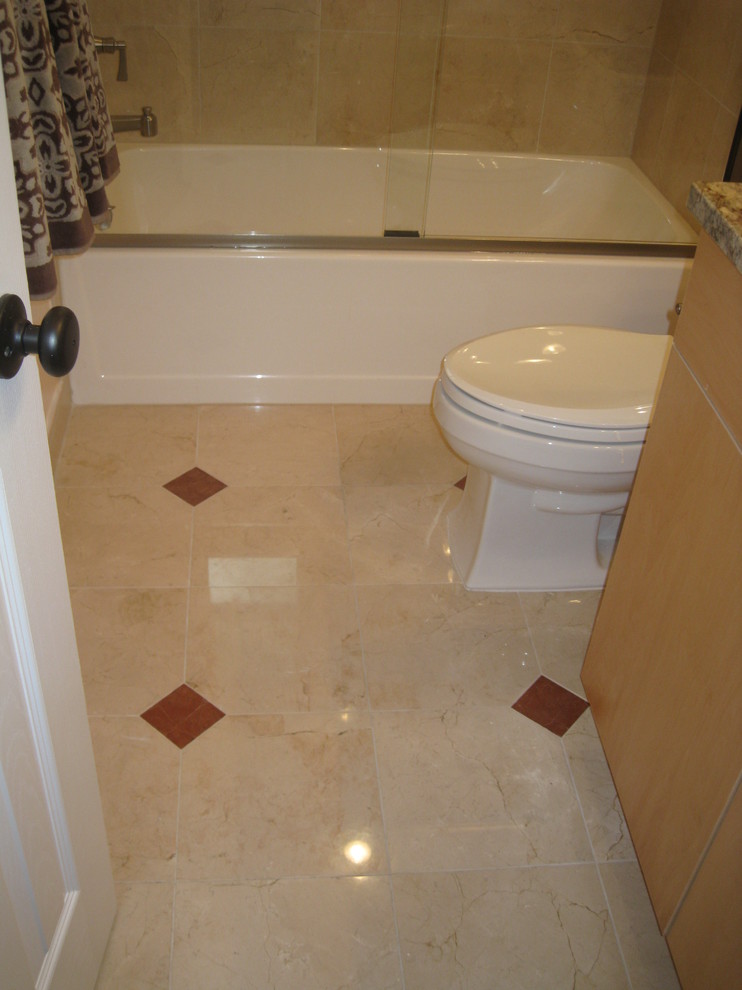 Photo of a large traditional kids bathroom in DC Metro with an alcove tub, marble floors, an undermount sink, light wood cabinets and a shower/bathtub combo.