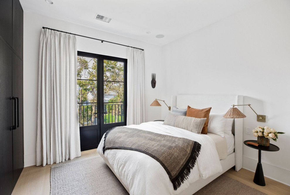 Inspiration for a mid-sized transitional guest bedroom in Los Angeles with white walls, light hardwood floors, no fireplace, beige floor and coffered.