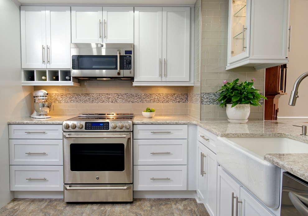 Inspiration for a small transitional kitchen in Philadelphia with a farmhouse sink, shaker cabinets, white cabinets, quartz benchtops, stainless steel appliances and no island.