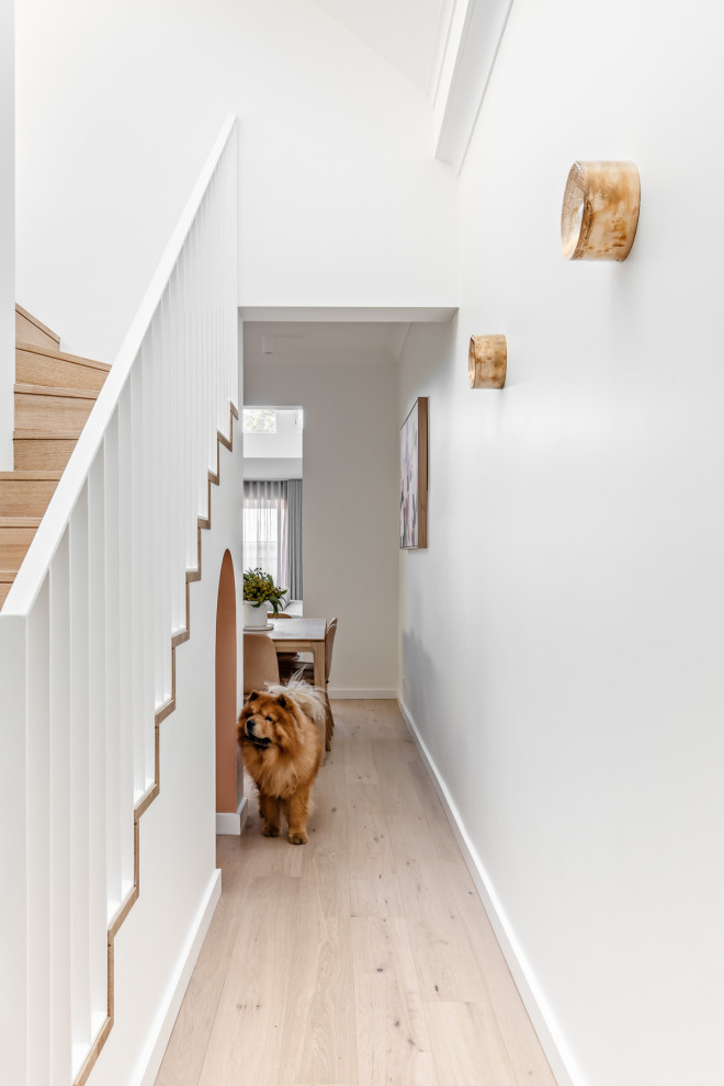 This is an example of a small contemporary wood l-shaped staircase in Sydney with wood risers and metal railing.