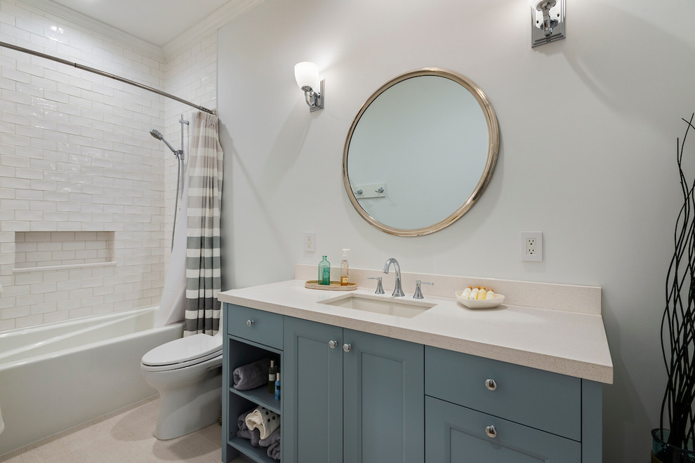 Inspiration for a small transitional 3/4 bathroom in Vancouver with recessed-panel cabinets, grey cabinets, an alcove tub, a shower/bathtub combo, a one-piece toilet, white tile, subway tile, grey walls, an undermount sink, engineered quartz benchtops, beige floor, a shower curtain and white benchtops.