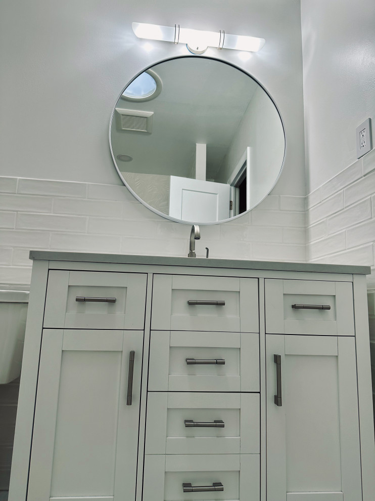 Inspiration for a small contemporary white tile and ceramic tile ceramic tile, gray floor and single-sink bathroom remodel in Wilmington with shaker cabinets, white cabinets, a two-piece toilet, white walls, an undermount sink, marble countertops, a freestanding vanity and gray countertops
