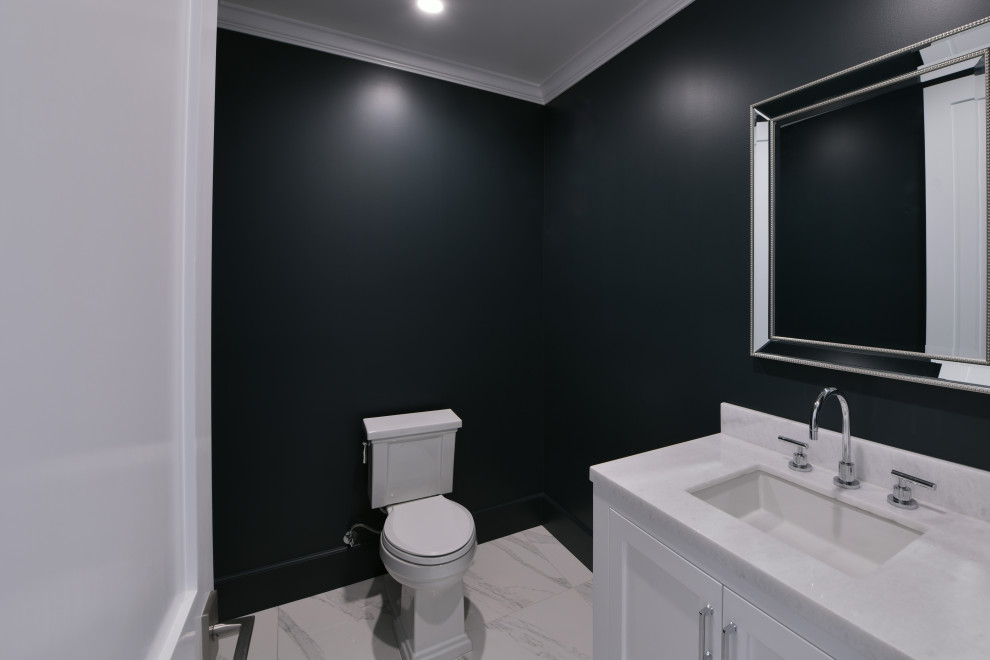 This is an example of a small classic cloakroom in Los Angeles with shaker cabinets, white cabinets, a one-piece toilet, white tiles, green walls, porcelain flooring, a pedestal sink, granite worktops, white floors, white worktops, a built in vanity unit and a vaulted ceiling.