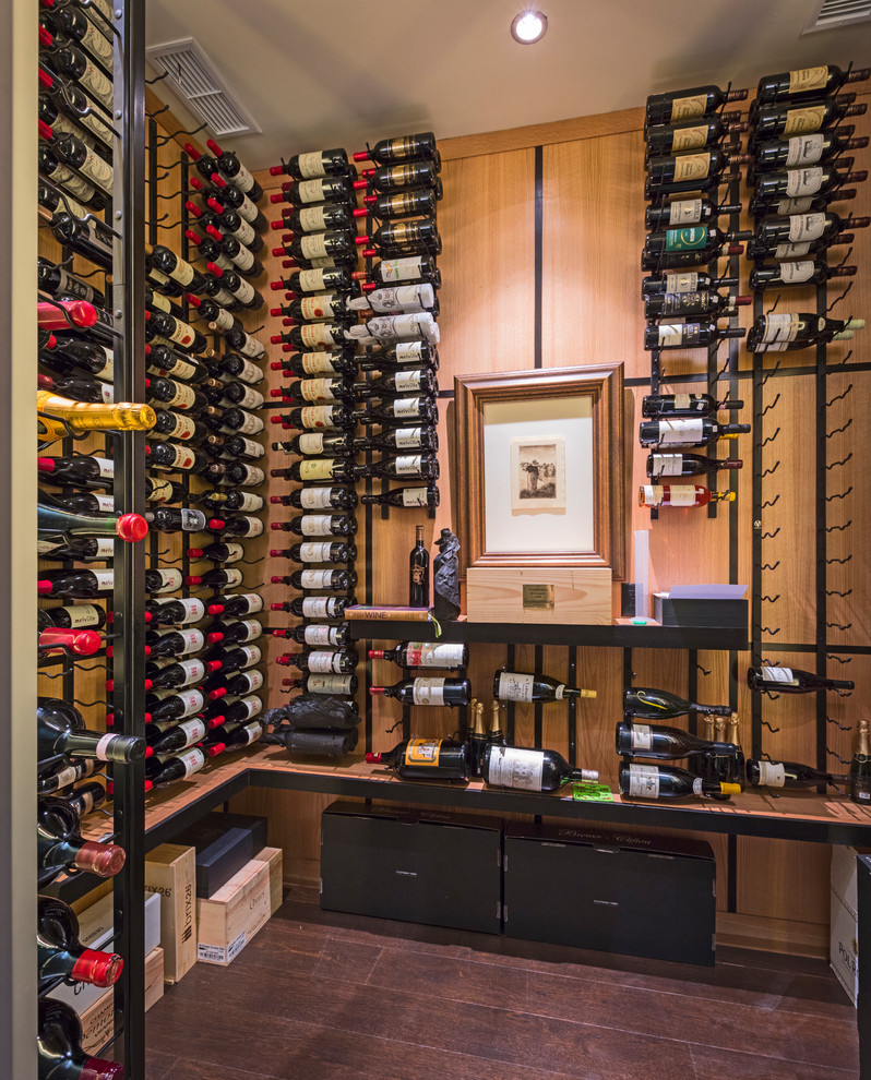 Contemporary wine cellar in Denver with dark hardwood floors, storage racks and brown floor.