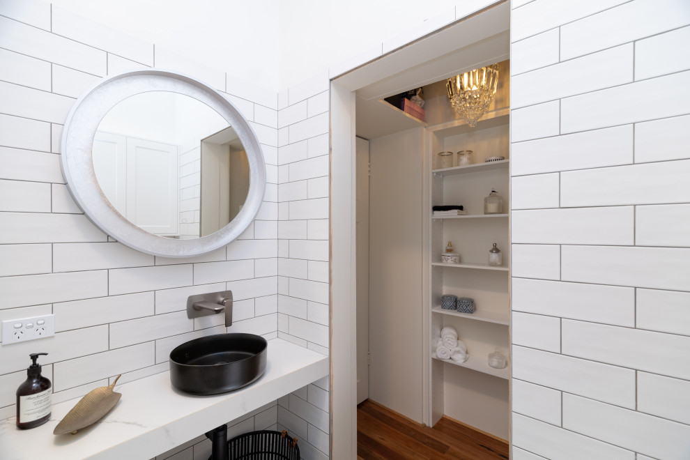 Inspiration for a small contemporary 3/4 bathroom in Sydney with white tile, porcelain tile, white walls, porcelain floors, a vessel sink, tile benchtops, white floor, white benchtops, a shower seat and a single vanity.