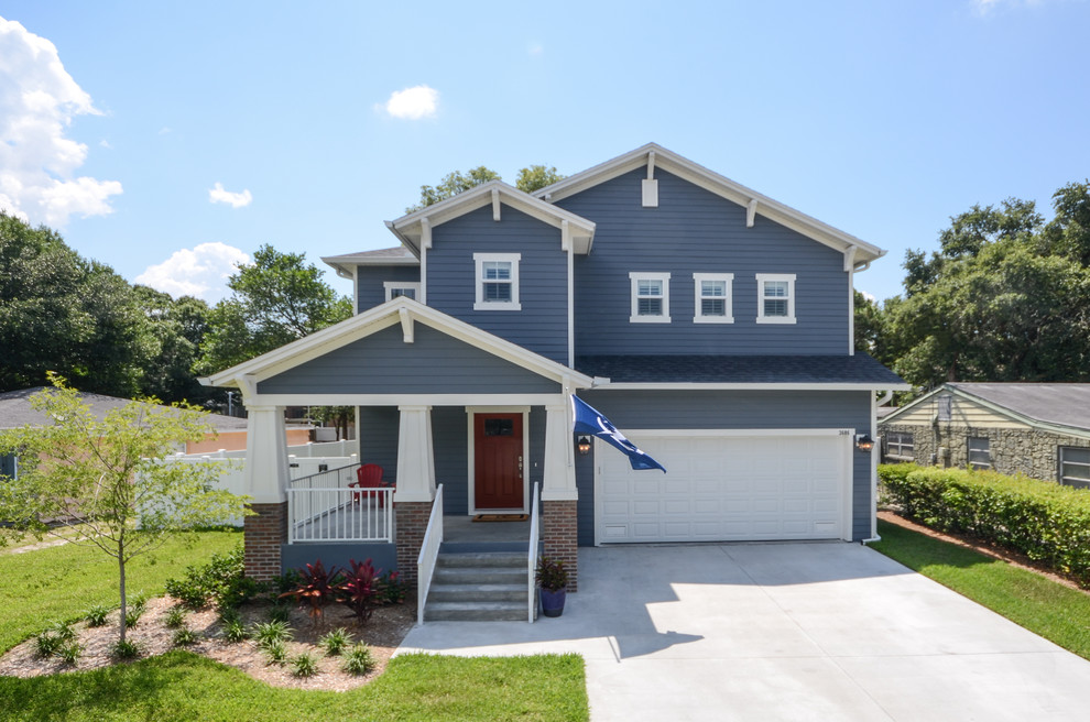 This is an example of a mid-sized arts and crafts two-storey blue exterior in Tampa with concrete fiberboard siding and a gable roof.