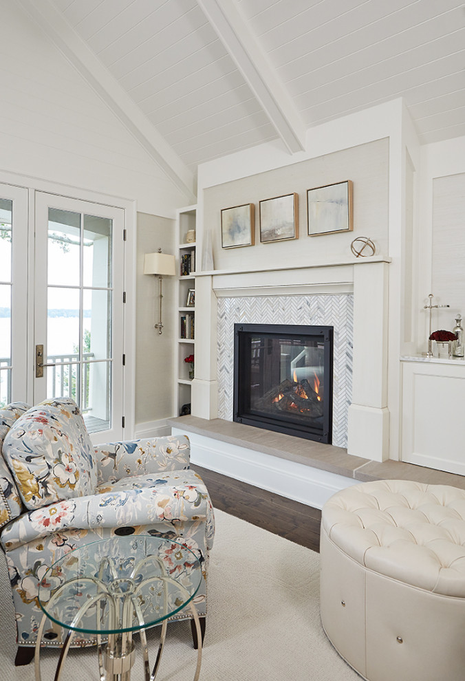 Photo of a mid-sized eclectic study room in Grand Rapids with white walls, medium hardwood floors, a two-sided fireplace, a tile fireplace surround and a freestanding desk.