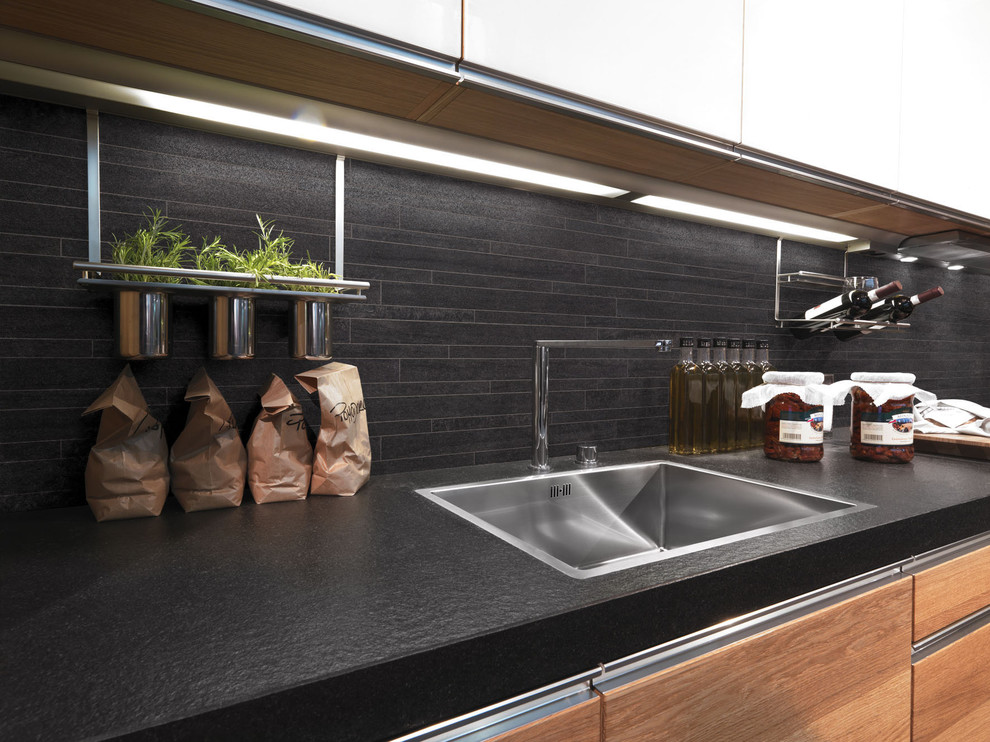 Inspiration for a mid-sized contemporary galley eat-in kitchen in Brisbane with black splashback, stainless steel appliances and porcelain floors.