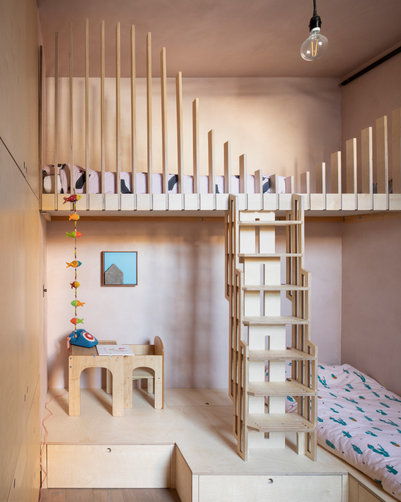 Inspiration for a small contemporary gender-neutral kids' bedroom for kids 4-10 years old in Other with beige walls, medium hardwood floors and brown floor.