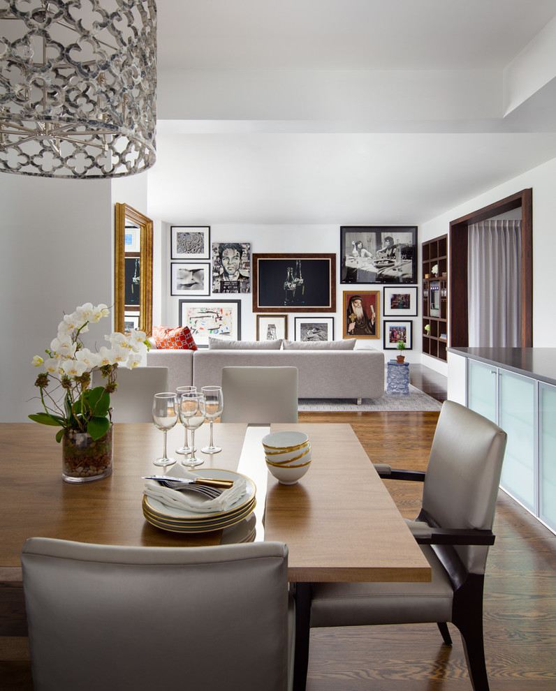 Photo of a mid-sized contemporary kitchen/dining combo in New York with white walls and dark hardwood floors.