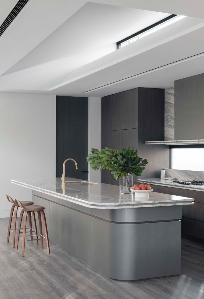 Photo of an expansive contemporary galley open plan kitchen in Sydney with a double-bowl sink, flat-panel cabinets, dark wood cabinets, marble benchtops, multi-coloured splashback, marble splashback, panelled appliances, medium hardwood floors, with island, brown floor, multi-coloured benchtop and vaulted.