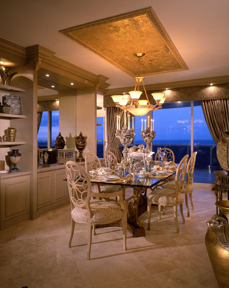 This is an example of a transitional separate dining room in Miami with marble floors.