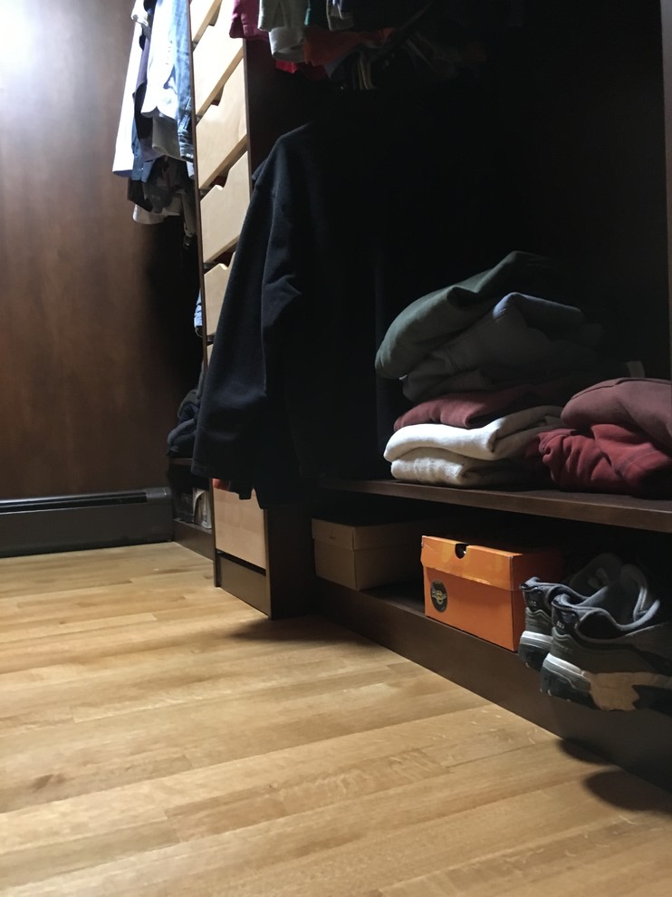Example of a mid-sized transitional light wood floor walk-in closet design with open cabinets and dark wood cabinets