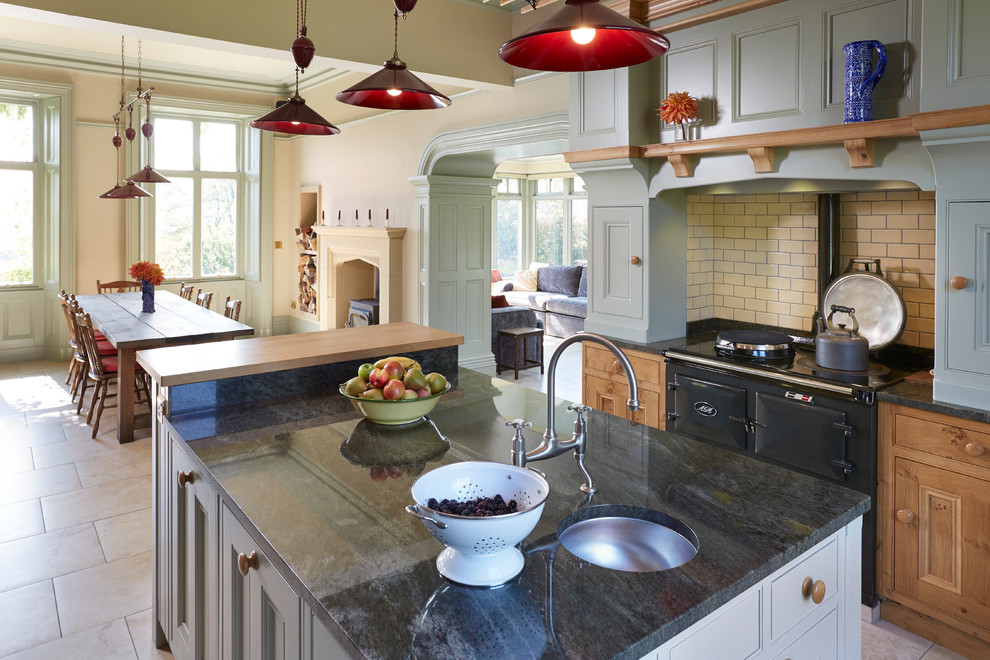 This is an example of a large traditional eat-in kitchen in Other with an undermount sink, beaded inset cabinets, granite benchtops, ceramic floors and with island.