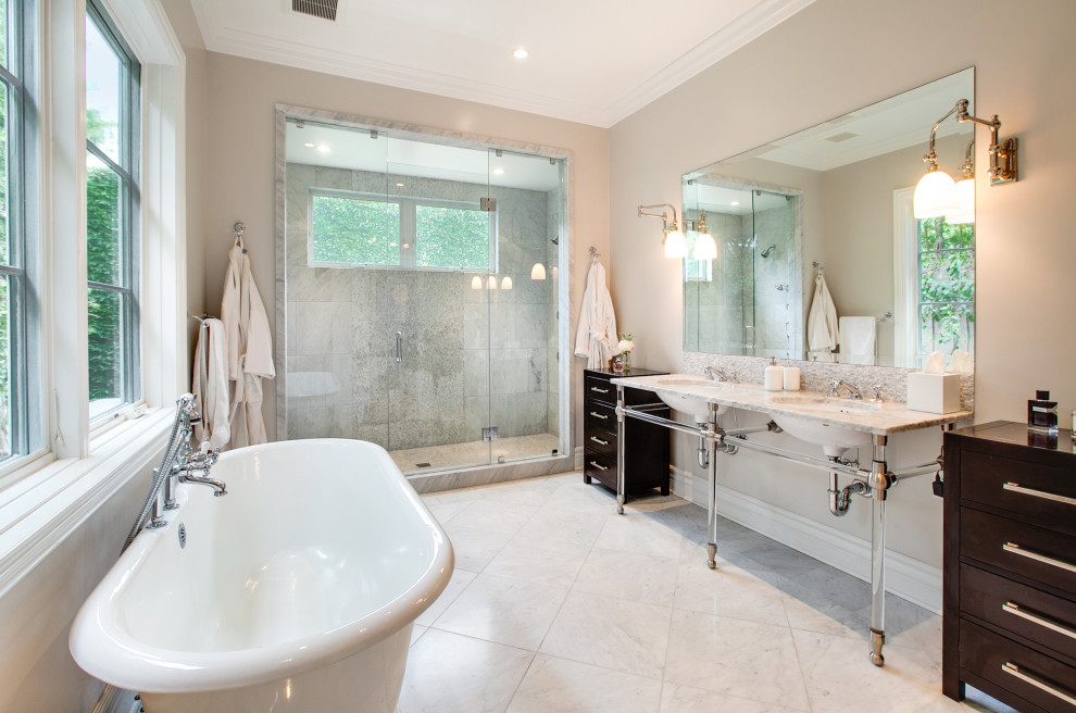 Inspiration for a large transitional master bathroom in Los Angeles with a freestanding tub, an alcove shower, grey walls, a console sink, grey floor, a hinged shower door, grey benchtops, a double vanity and a built-in vanity.