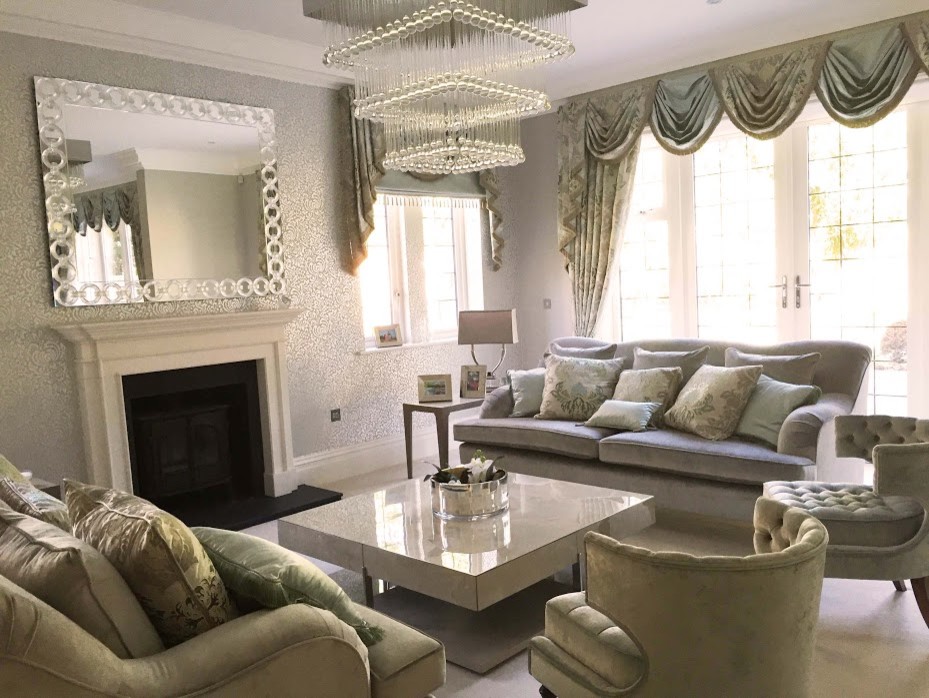 Photo of a mid-sized contemporary formal enclosed living room in Hertfordshire with white walls, carpet, a standard fireplace, a stone fireplace surround and no tv.
