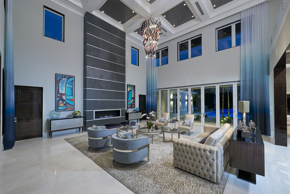 Expansive contemporary formal open concept living room in Miami with beige walls, marble floors, a standard fireplace, a stone fireplace surround and no tv.