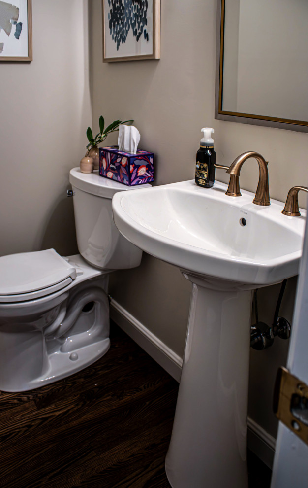 Idéer för små vintage toaletter, med en toalettstol med separat cisternkåpa, beige väggar, mellanmörkt trägolv, ett piedestal handfat och brunt golv