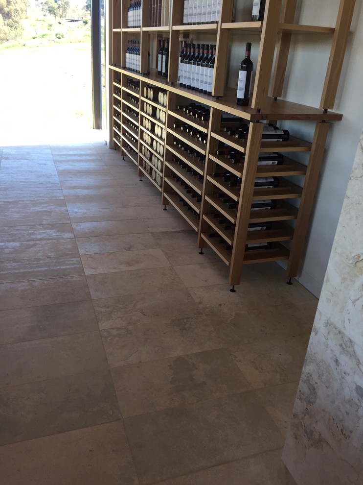 Inspiration for an expansive contemporary dining room in Adelaide with travertine floors and a stone fireplace surround.