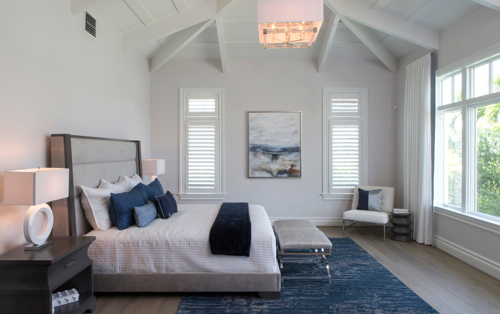 Inspiration for a large transitional guest bedroom in Miami with white walls, painted wood floors and no fireplace.