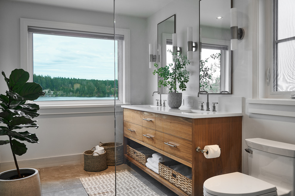 Photo of a mid-sized beach style master bathroom in Vancouver with grey cabinets, an open shower, a one-piece toilet, white walls, porcelain floors, a vessel sink, quartzite benchtops, grey floor, an open shower, white benchtops and flat-panel cabinets.