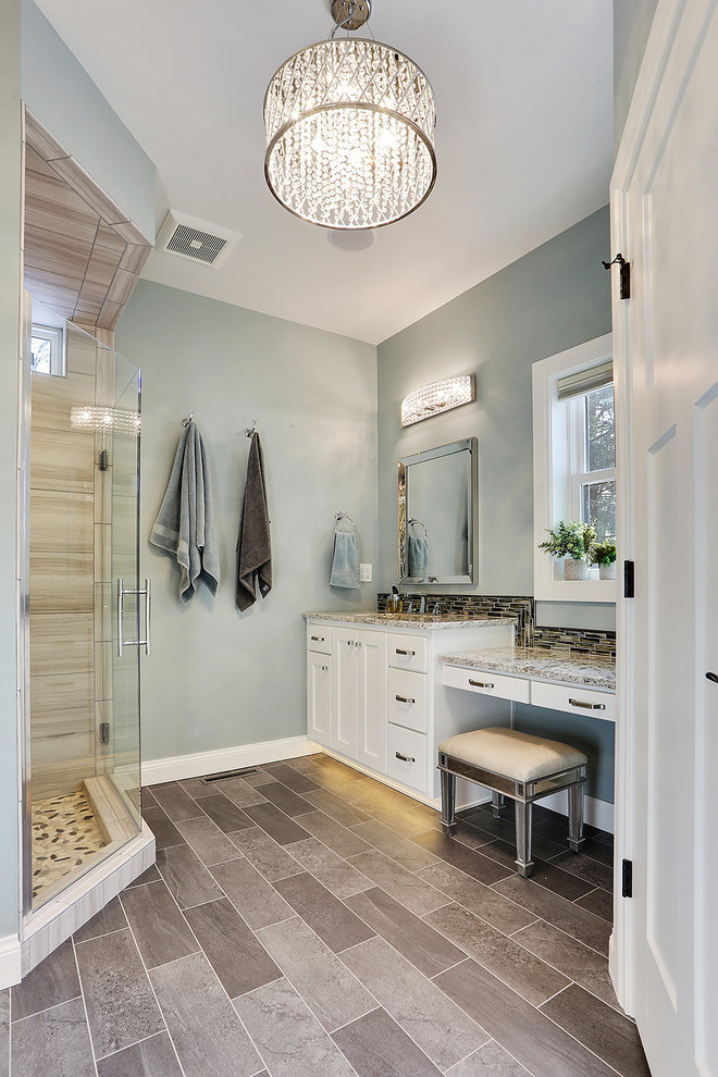 Photo of a transitional master bathroom in Other with shaker cabinets, white cabinets, a corner shower, beige tile, blue walls, an undermount sink, grey floor, a hinged shower door and grey benchtops.
