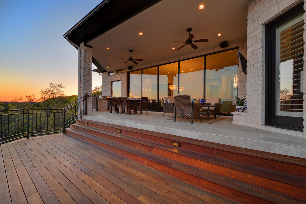 Inspiration for a large transitional backyard patio kitchen remodel in Austin with decking and a roof extension
