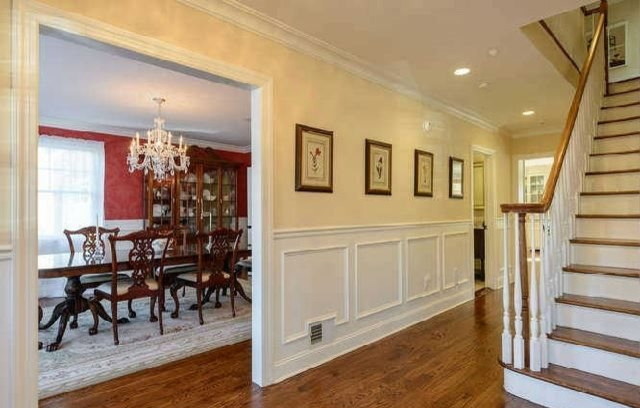 Large traditional foyer in New York with beige walls, medium hardwood floors, a single front door and a white front door.